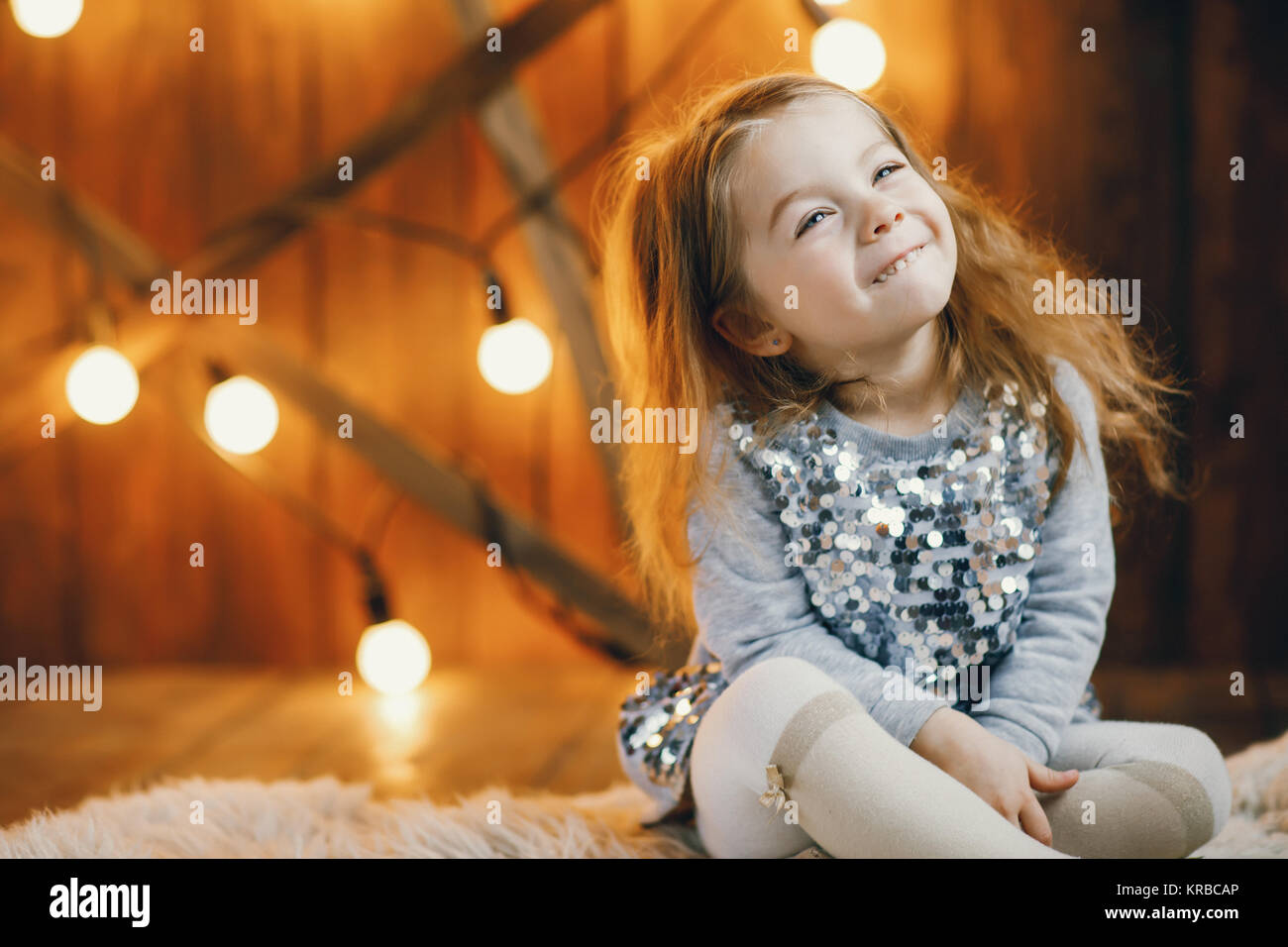 little blonde baby girl sitting on the floor Stock Photo - Alamy