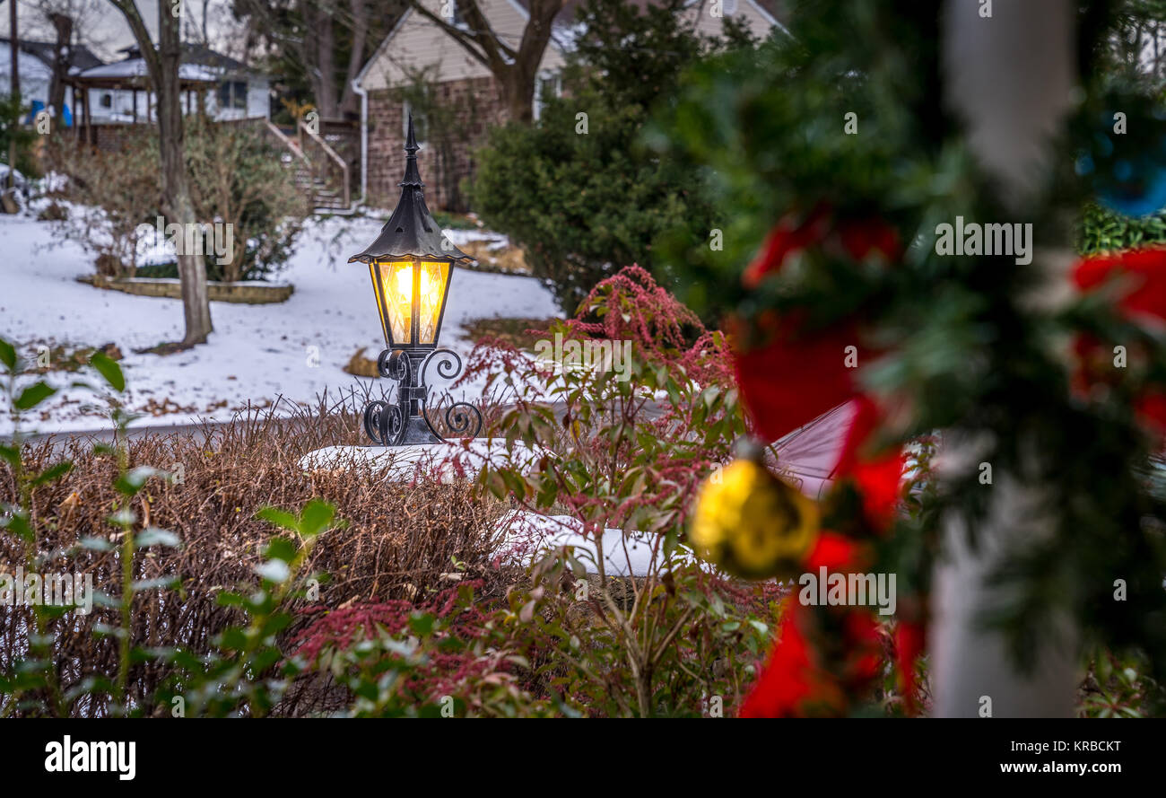 Illuminated outdoor lantern with white snow gives an extra charater for a holiday decor. Holiday concept. Stock Photo