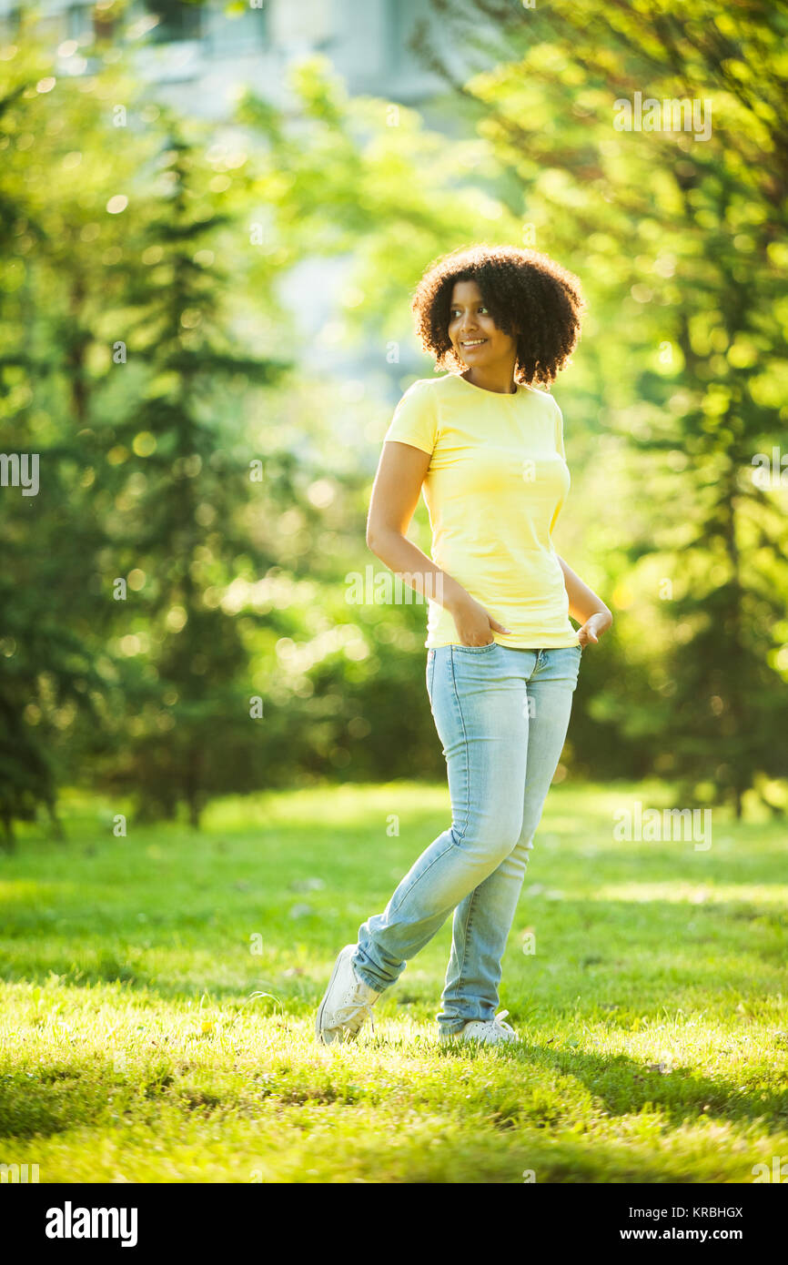 Young woman walking in park Stock Photo - Alamy