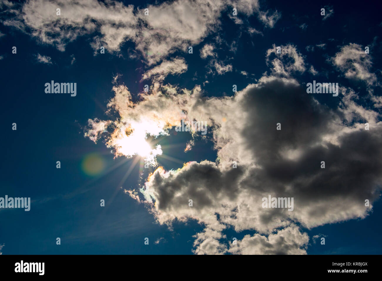 Sunbeams through the white clouds and deep blue sky Stock Photo