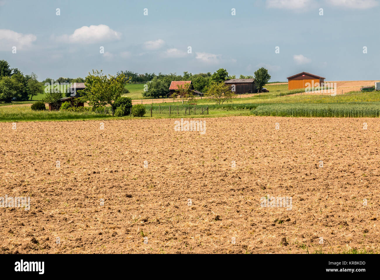 Big brown fields with fertile soil and farms Stock Photo