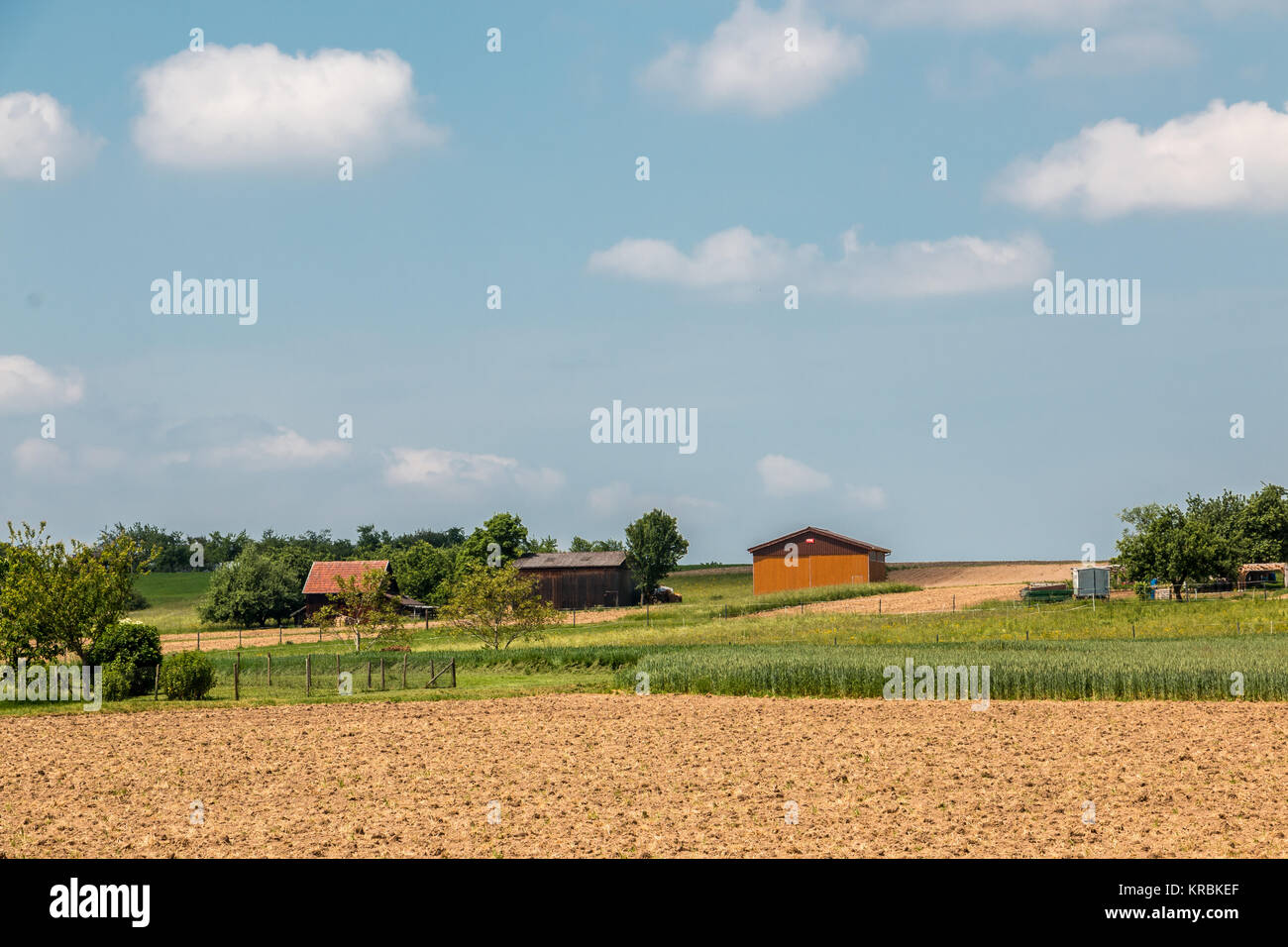 Big brown fields with fertile soil and farms Stock Photo