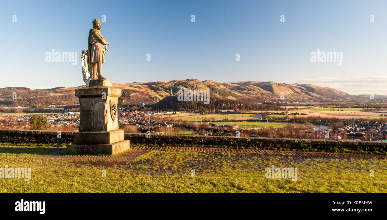 Stirling, Scotland, UK - January 22, 2012: Morning sun illuminates the statue of Robert the Bruce overlooking the Ochil Hills and the valley of the Ri Stock Photo