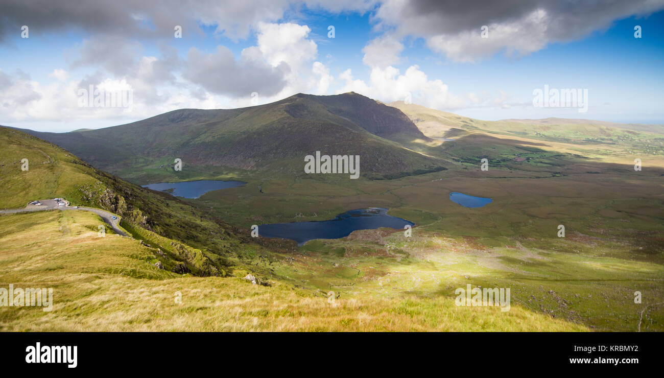 Brandon Mountain, the highest mountain on Ireland's Dignle Peninsula, stands above a deep glacial valley and lakes to the west of Conor Pass in County Stock Photo