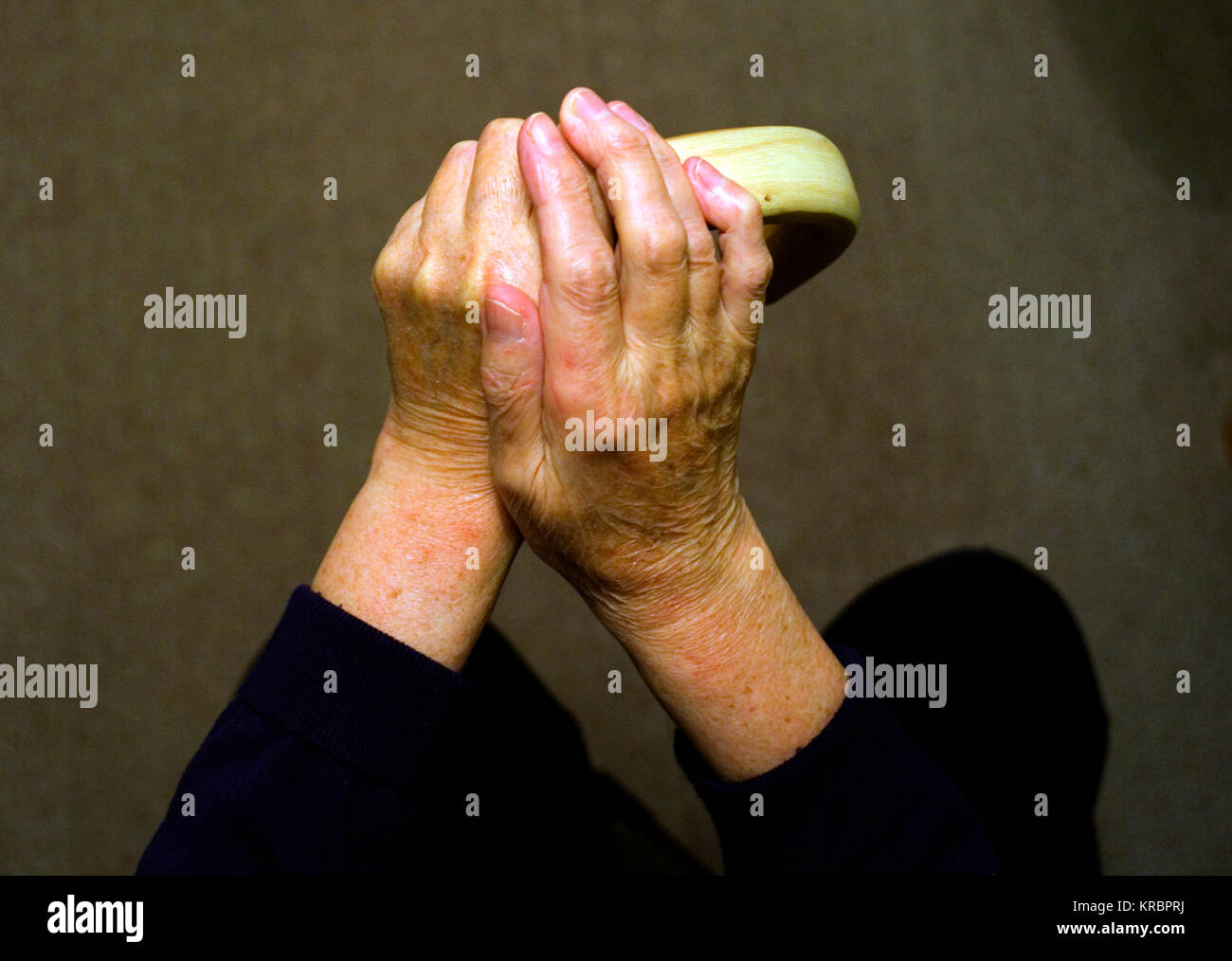 The hands of an elderly woman rest on the handle of a walking stick, in a posed photograph, in Harlow, Britain December 17, 2017 Stock Photo