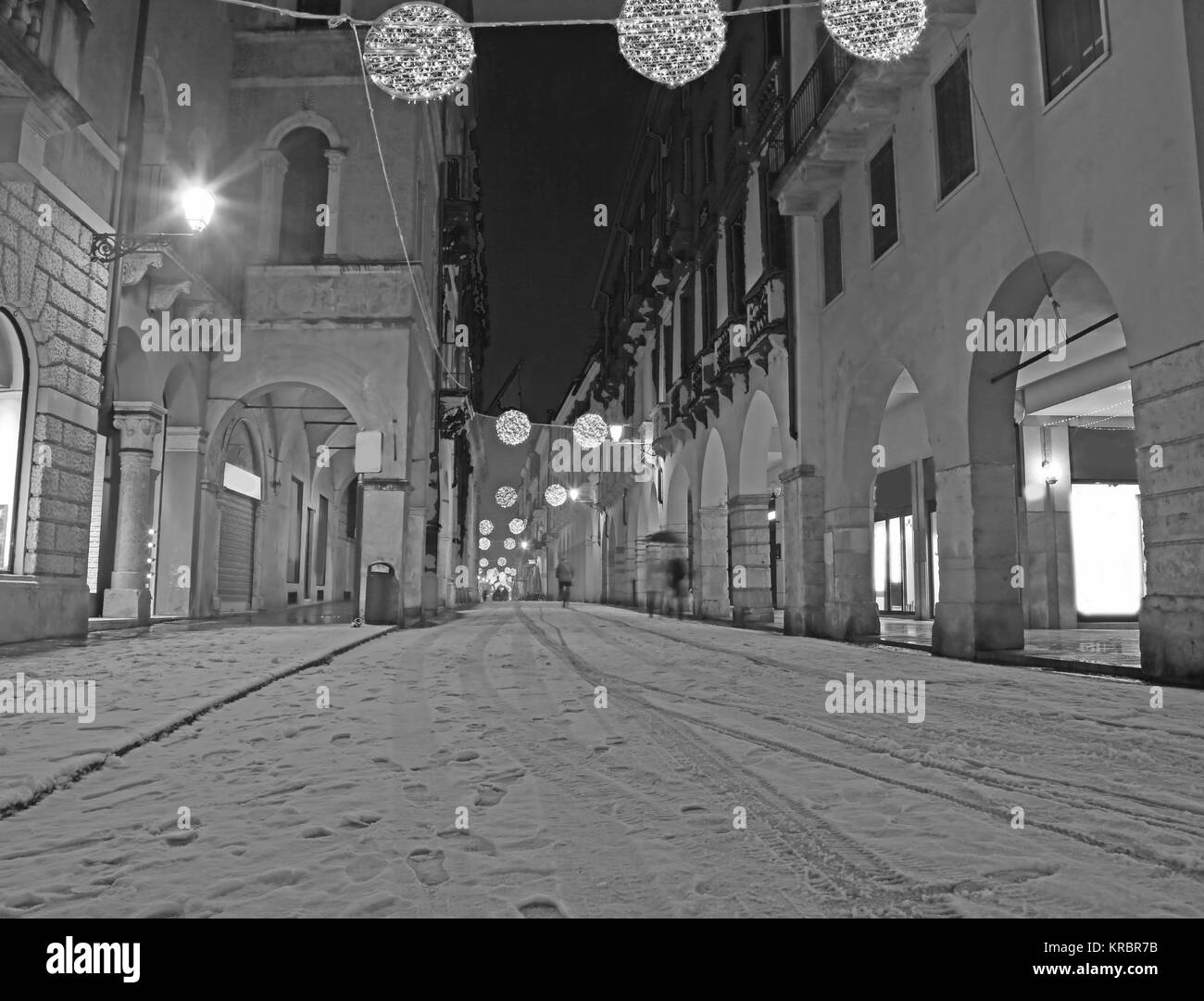 ain street in downtown called CORSO PALLADIO of Vicenza City in Italy with snow and black and white effect by night Stock Photo