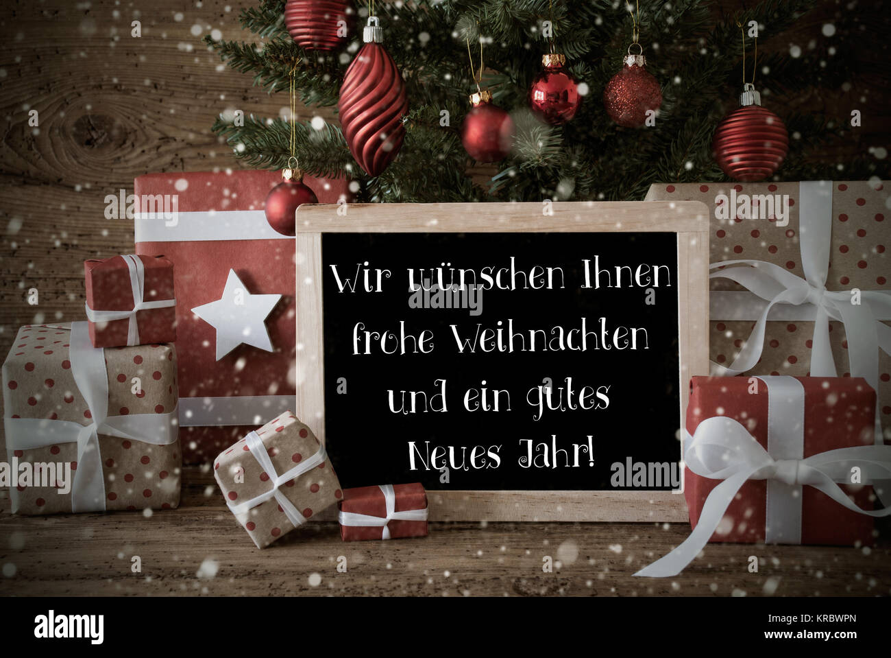 Chalkboard With German Text Wir Wuenschen Ihnen Frohe Weihnachten Und Ein Gutes Neues Jahr Means