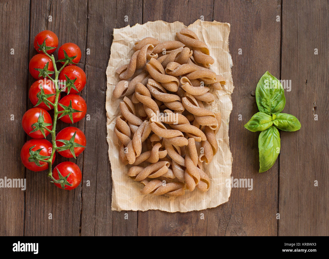 Whole wheat pasta, tomatoes and basil Stock Photo