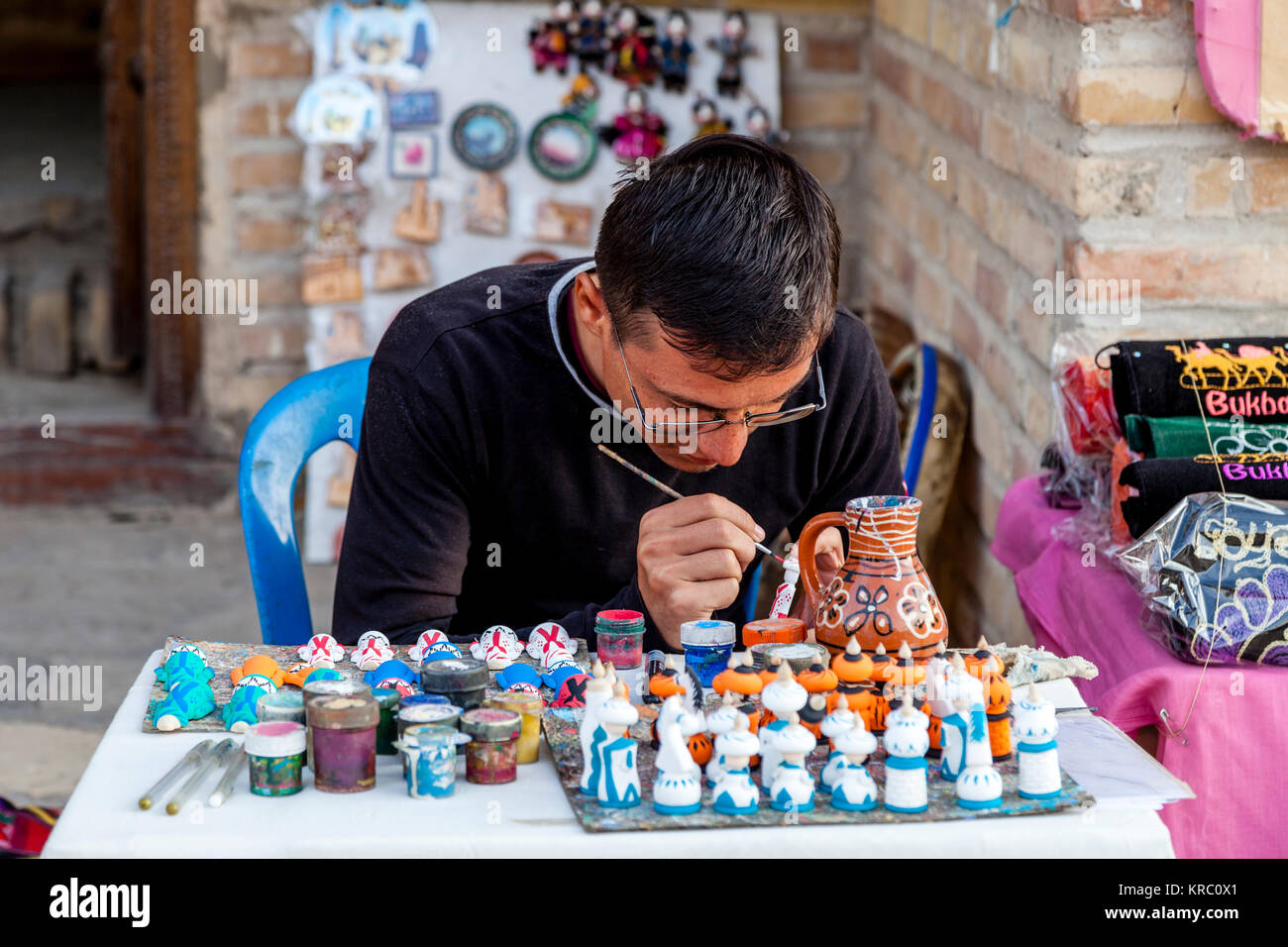 A Local Craftsman/Artist Working In The Market, Bukhara, Uzbekistan Stock Photo