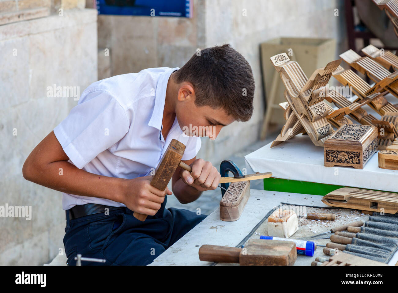 A Local Craftsman Working In The Market, Bukhara, Uzbekistan Stock Photo