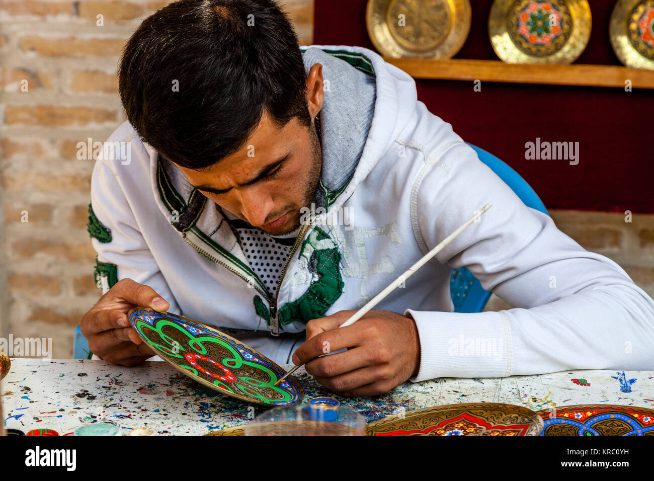 An Artist/Craftsman Working in The Market, Bukhara, Uzbekistan Stock Photo