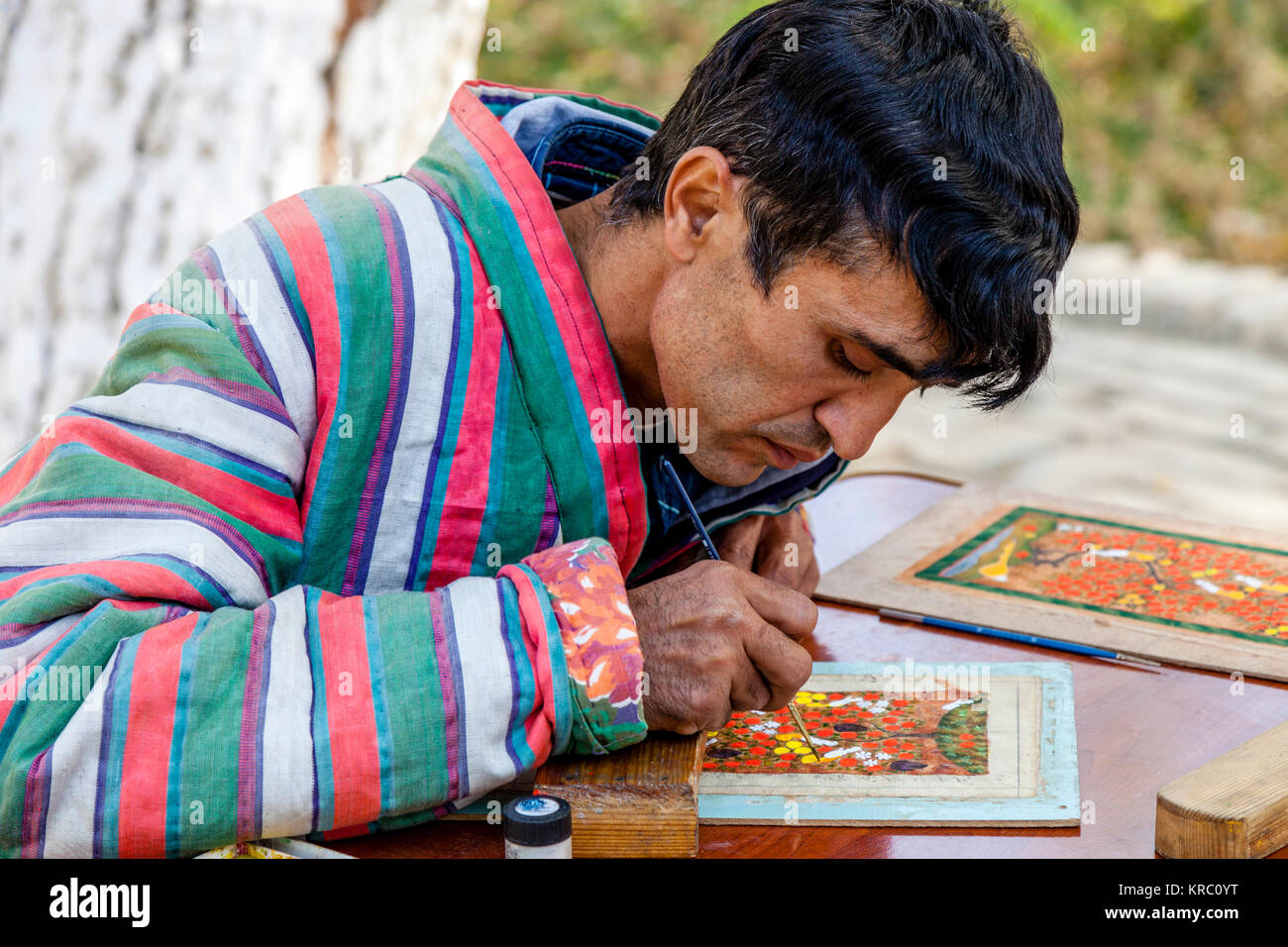 An Artist In Traditional Costume Working In The Market, Bukhara, Uzbekistan Stock Photo