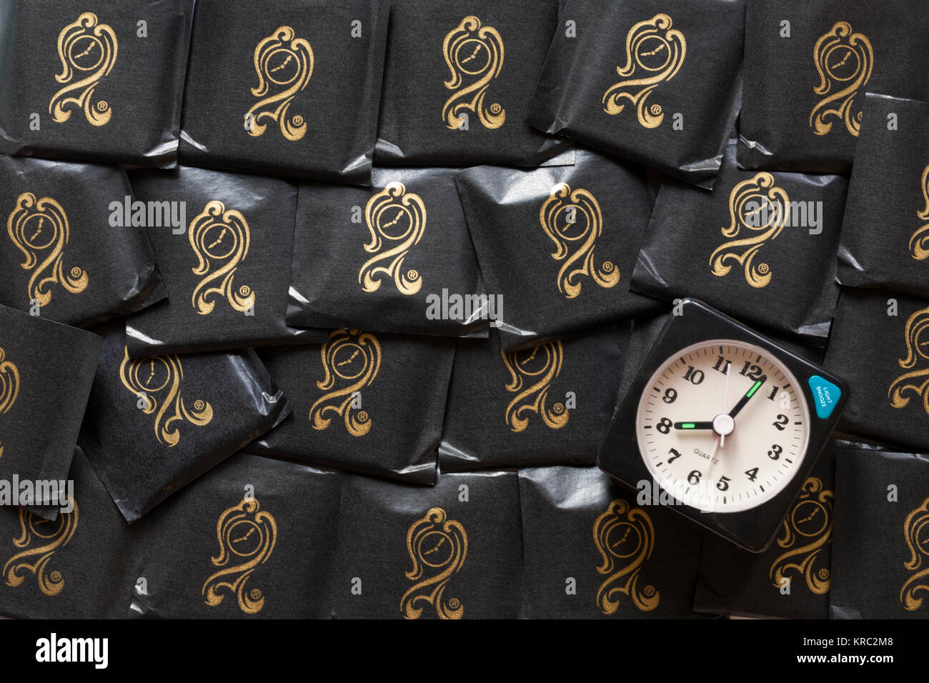 After Eight mint chocolate thins chocolates with alarm clock showing time as just past eight o'clock Stock Photo