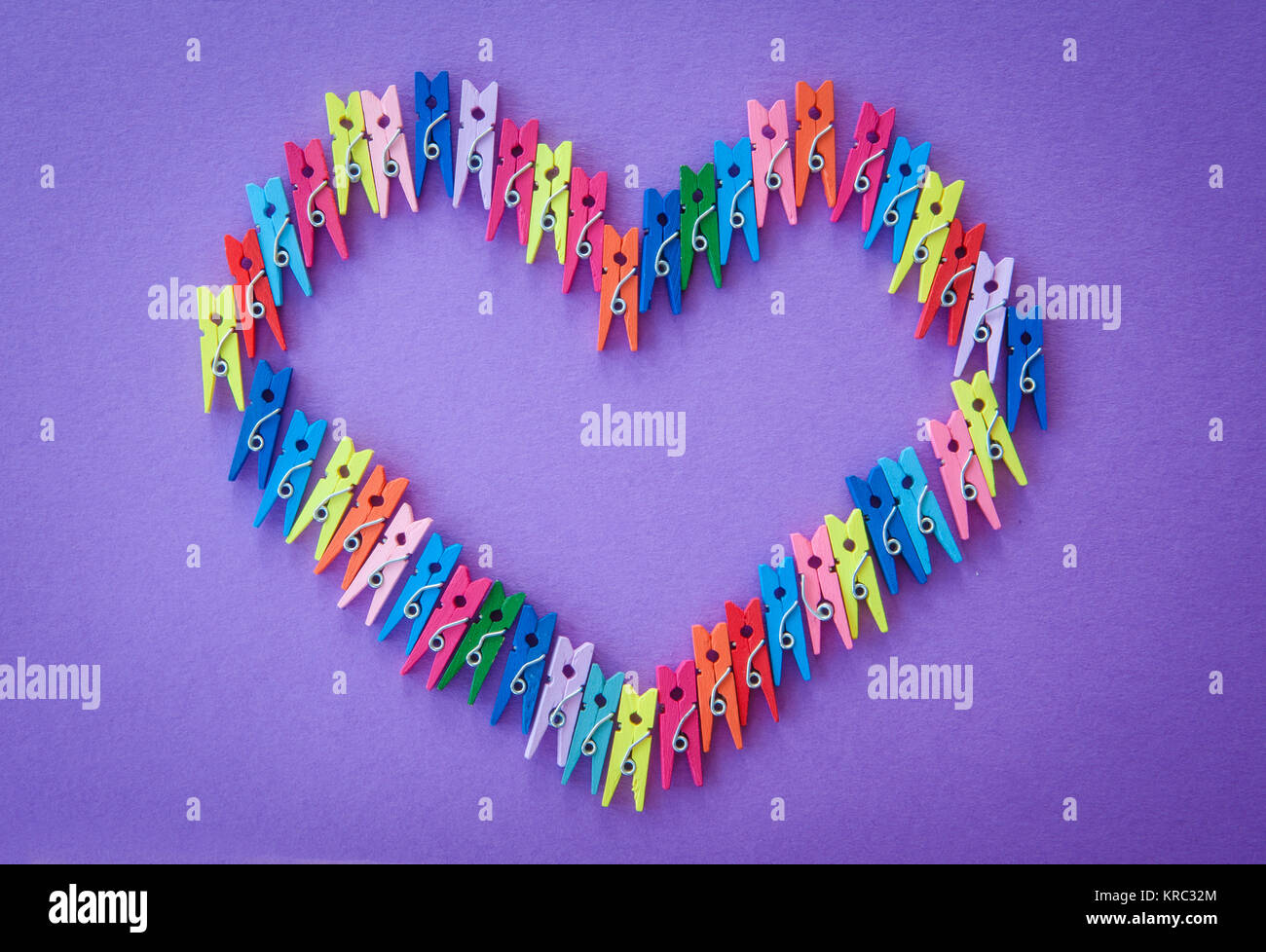 colorful clothes pins on purple Stock Photo