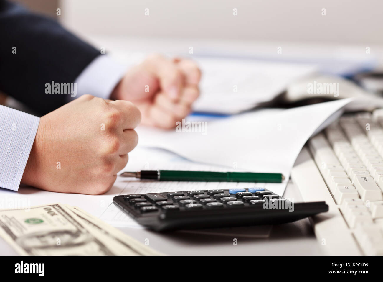 Angry business man hand banging fist on table in stress or problems at office workplace desk Stock Photo