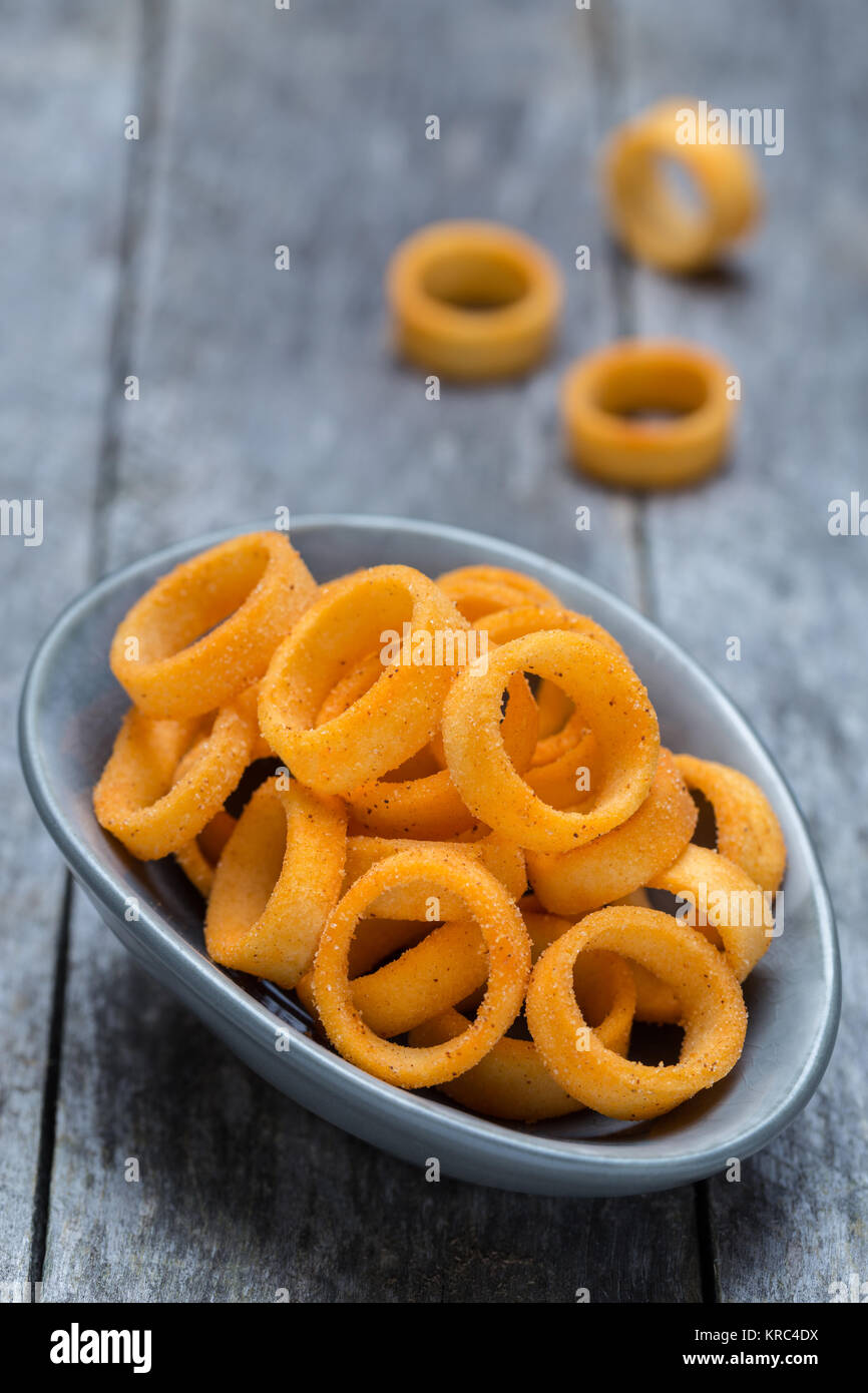 Potato rings on gray rustic wood. Stock Photo