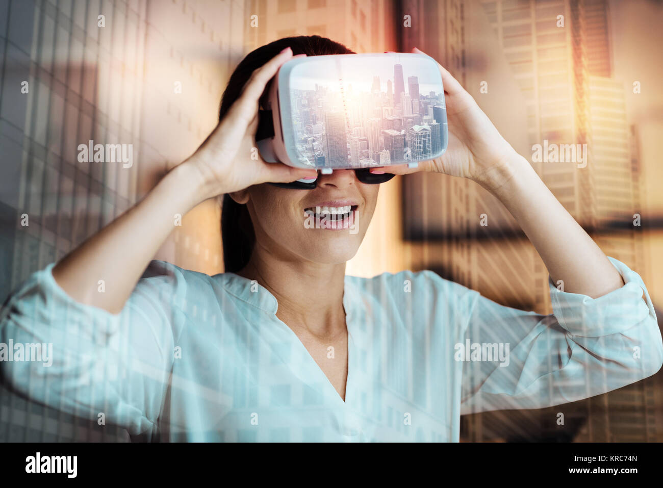 Cheerful young woman wearing a virtual reality headset Stock Photo - Alamy