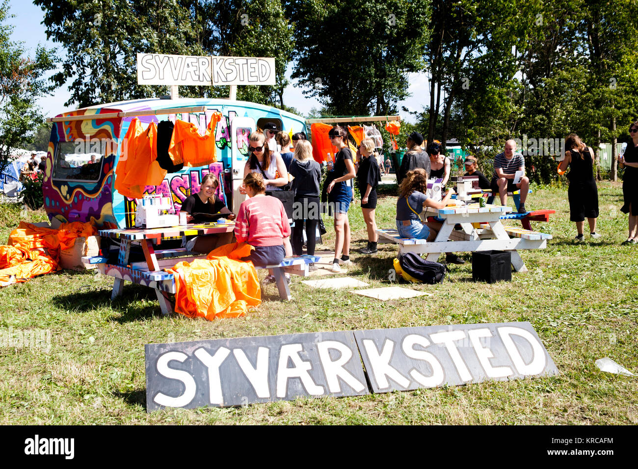 At the Roskilde Festival camping area lots of activities are going on like here where some festival guest have set up a sewing workshop for those interested. Denmark 30/06 2014. Stock Photo