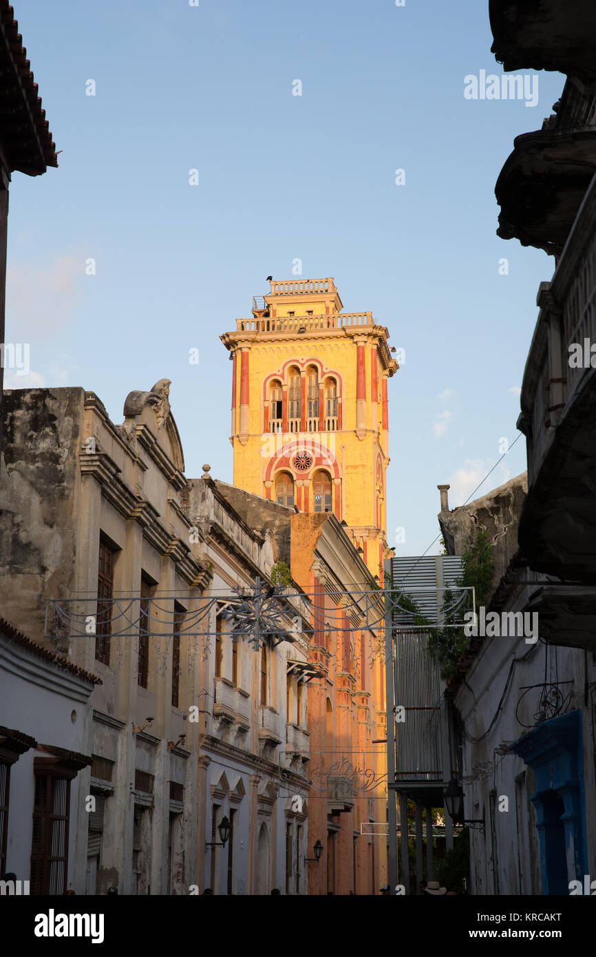 Sunset lights up the church at the end of a street in Cartagena old town Stock Photo