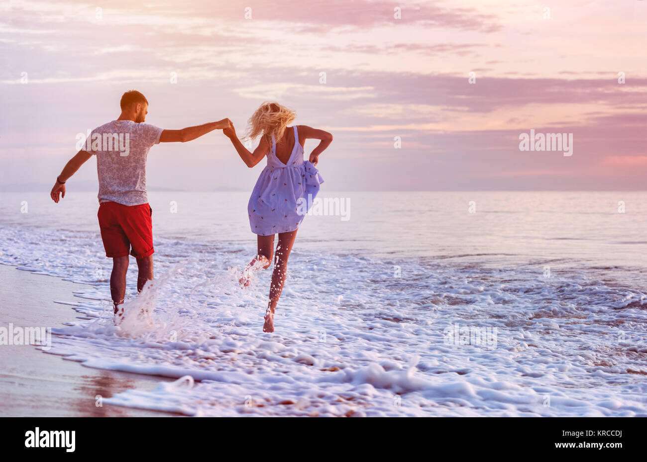 Happy couple at romantic sea sunset Stock Photo