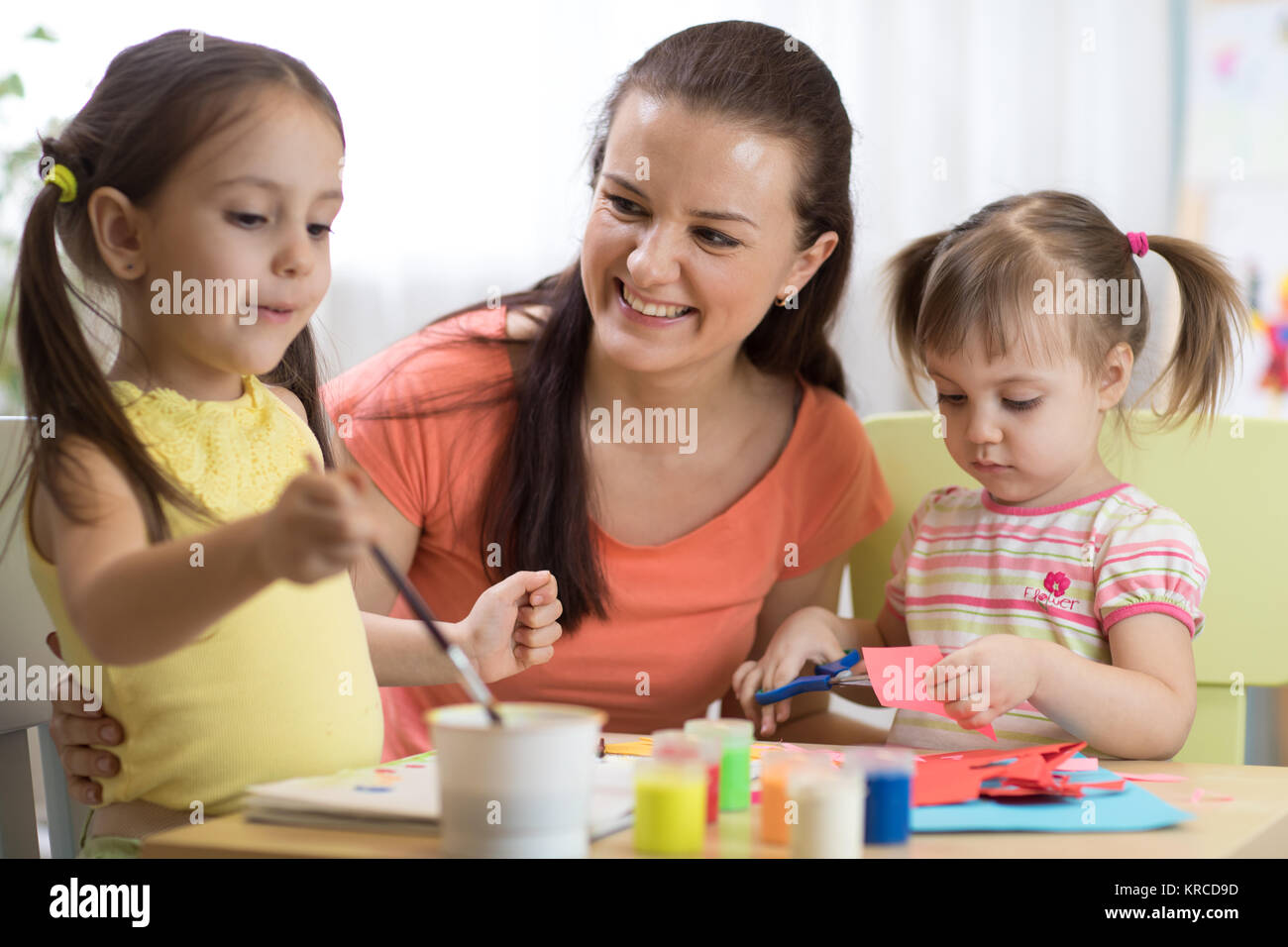 children girls and mother hands making at nursery at home Stock Photo