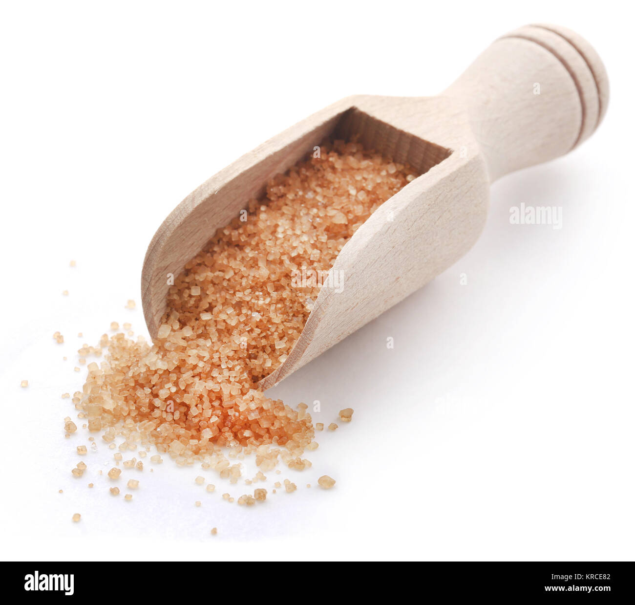 Brown sugar with wooden scoop over white background Stock Photo Alamy