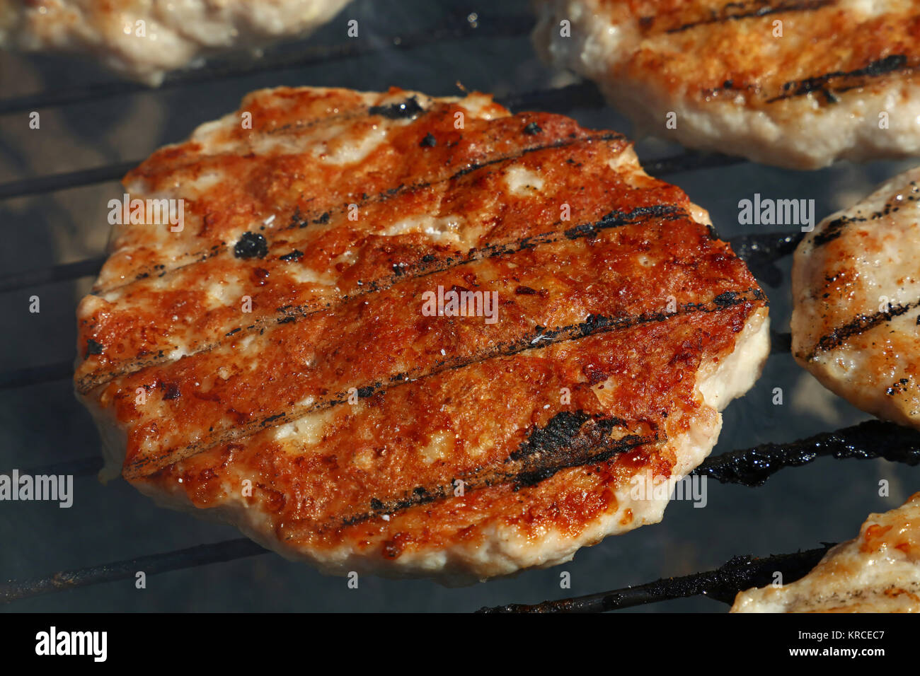 Chicken or turkey burger for hamburger on grill Stock Photo Alamy