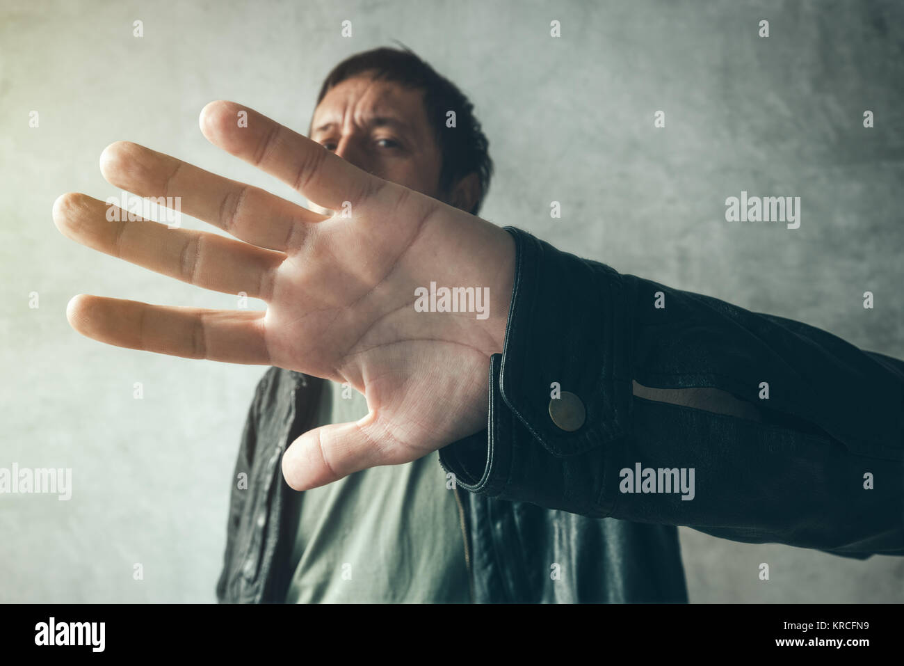 Celebrity male hiding face with hands from paparazzi photographers, no photos gesture Stock Photo