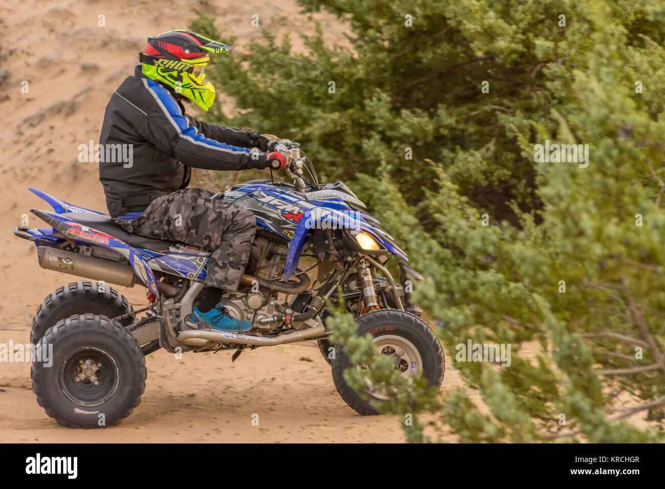 An adult having some fun with his quad bike at the sand dunes of Issos in South Corfu Greece.No motorsport related.The Greek government banned quads. Stock Photo