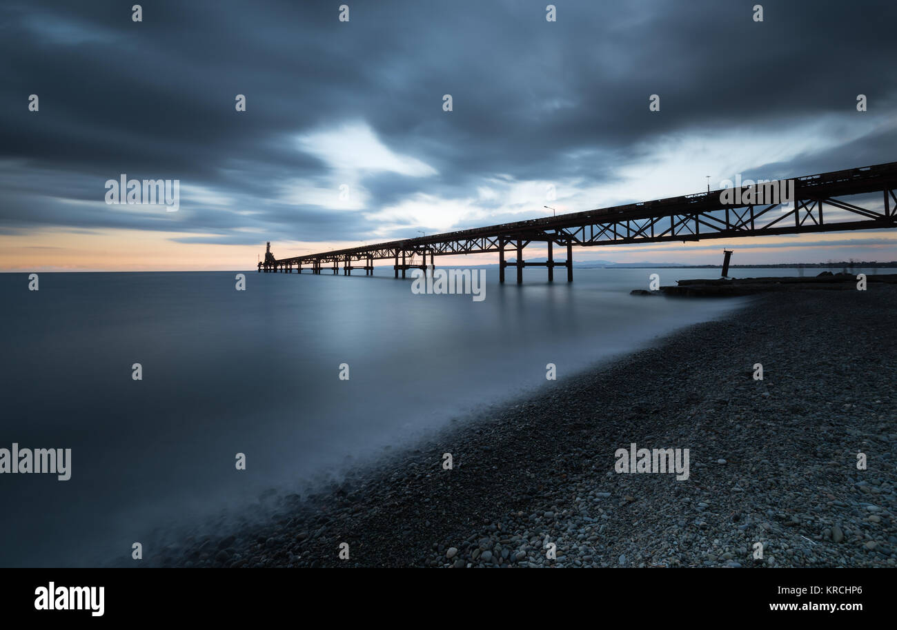 Seascape with jetty during a dramatic cloudy sunset  at Xeros area in Northern Cyprus Stock Photo