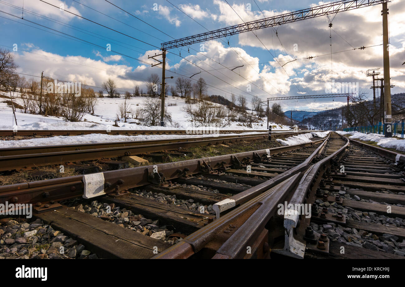 old railroad in winter mountain on a cloudy day. transportation background Stock Photo