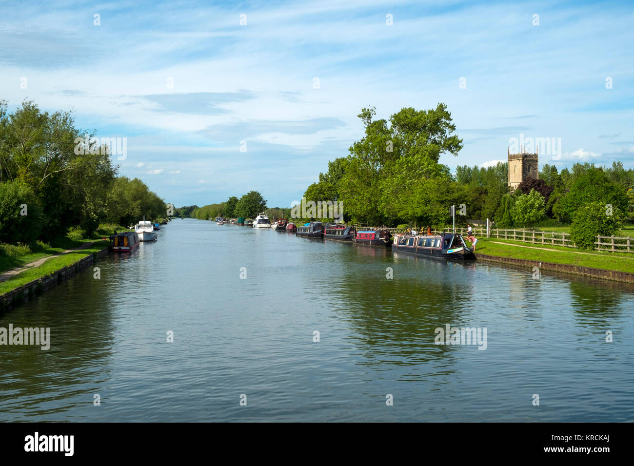 Glorious spring sunshine on boats moored near St Marys Church on the Gloucester & Sharpness Canal at Frampton on Severn, Gloucestershire, UK Stock Photo