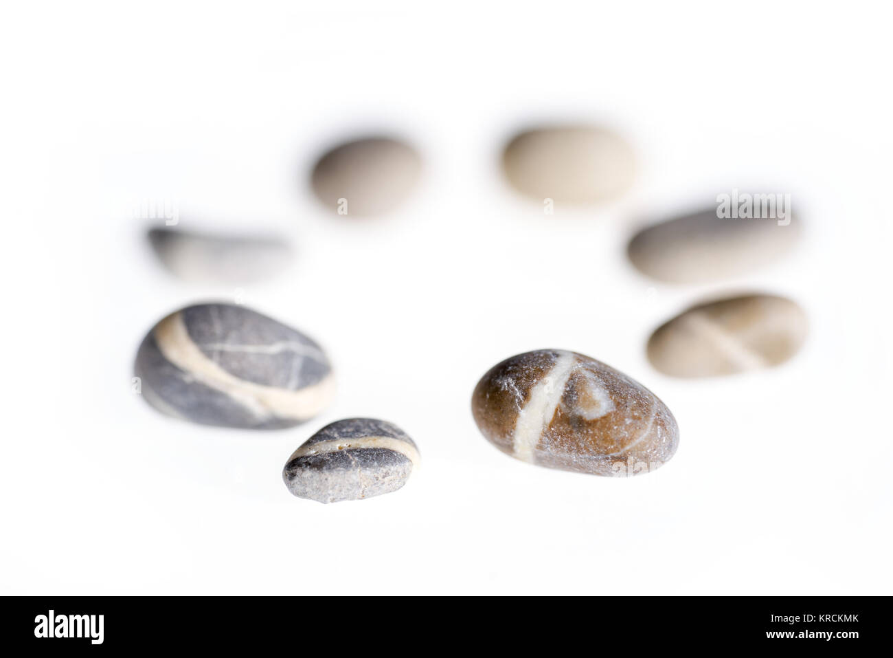 macro shot of a circular arrangement with small pebbles in white back Stock Photo