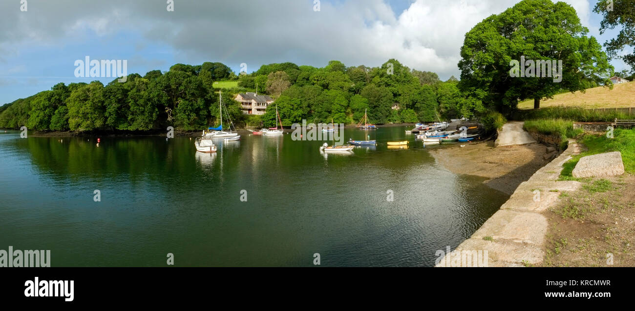Peaceful early summer morning on picturesque boat moorings in the Helford Estuary at old fashioned Port Navas, Cornwall, UK Stock Photo
