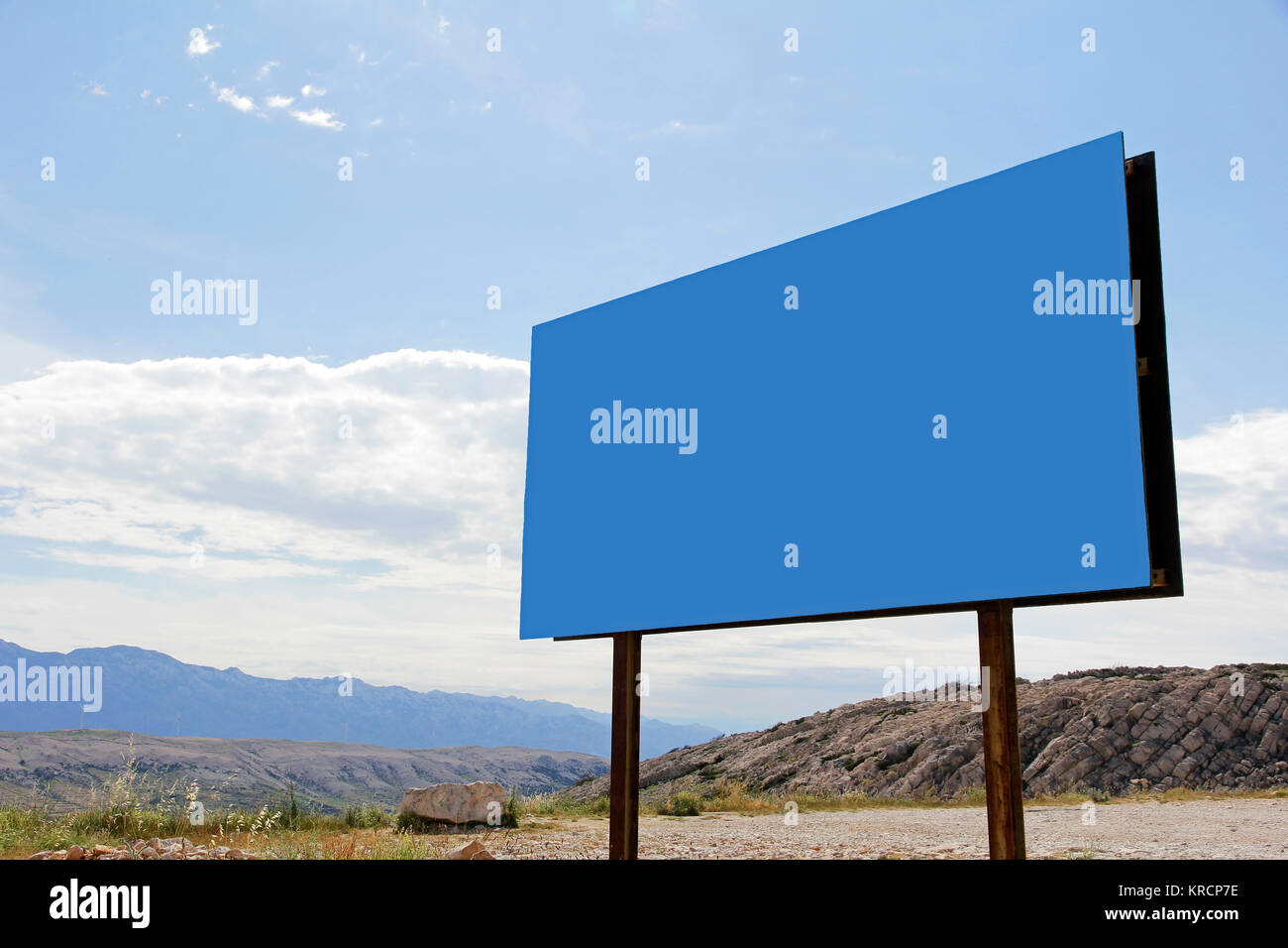 a large,blue,empty advertising sign in the mountains Stock Photo