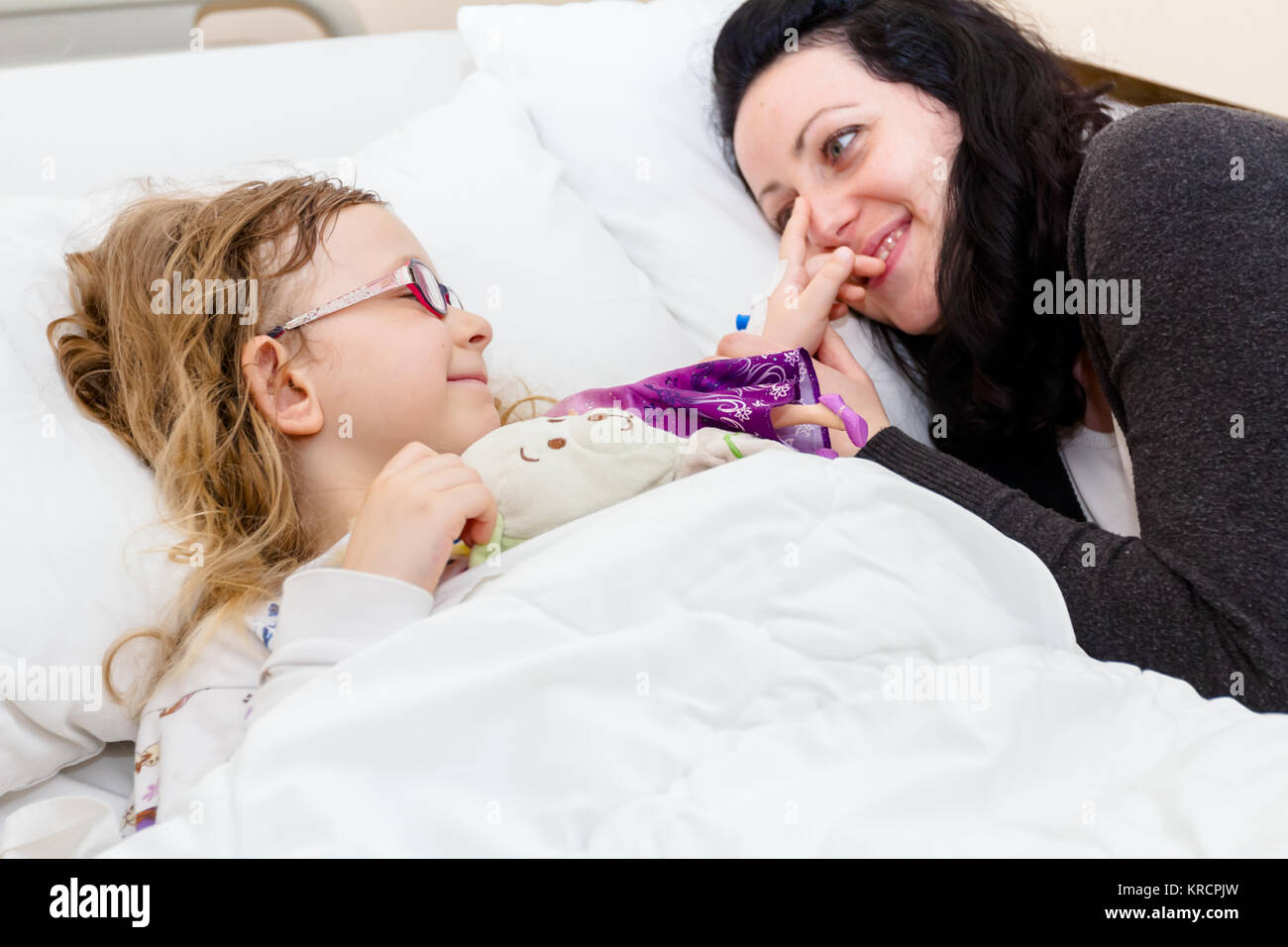 Mother care, worry about her sick daughter on hospital bed with her ...