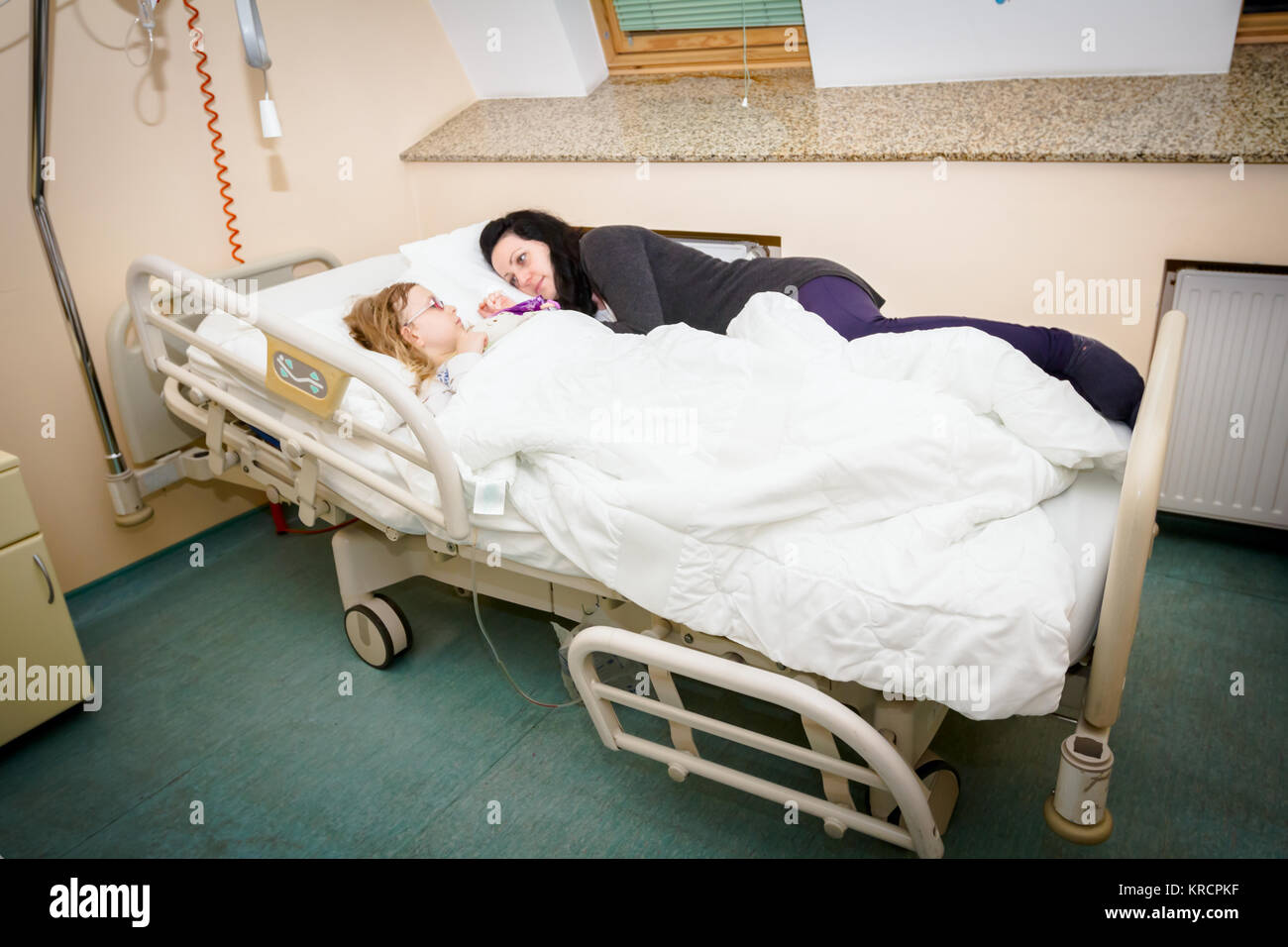 Mother care, worry about her sick daughter on hospital bed with her ...