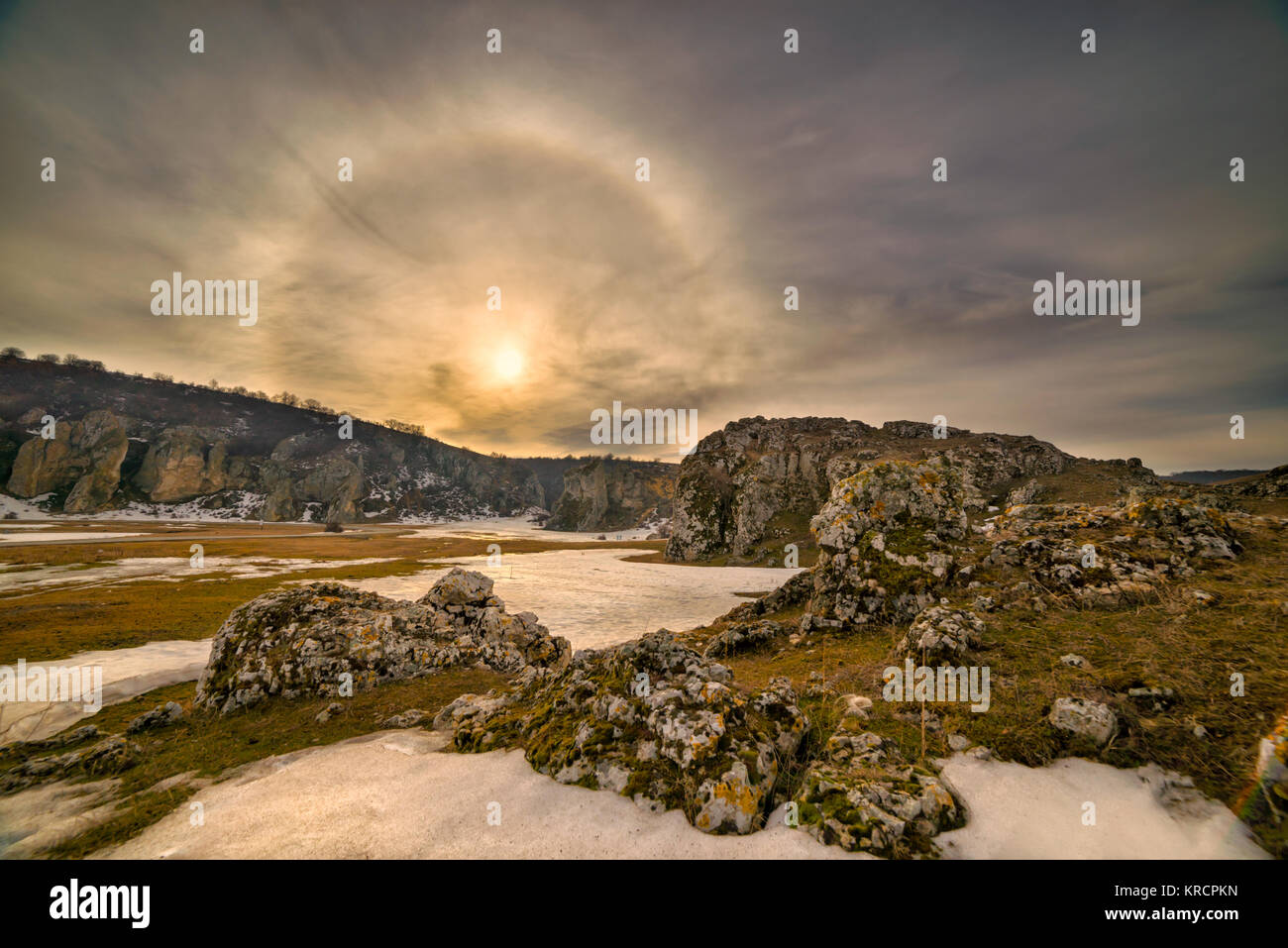Fantastic beautiful sun halo phenomenon at sunrise in Romania, Constanta at Cheile Dobrogei keys,or the sun with circular rainbow. Stock Photo