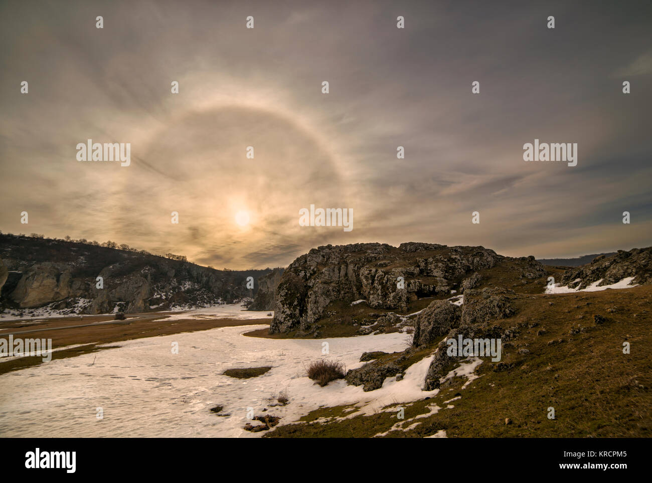 Fantastic beautiful sun halo phenomenon at sunrise in Romania, Constanta at Cheile Dobrogei keys,or the sun with circular rainbow. Stock Photo