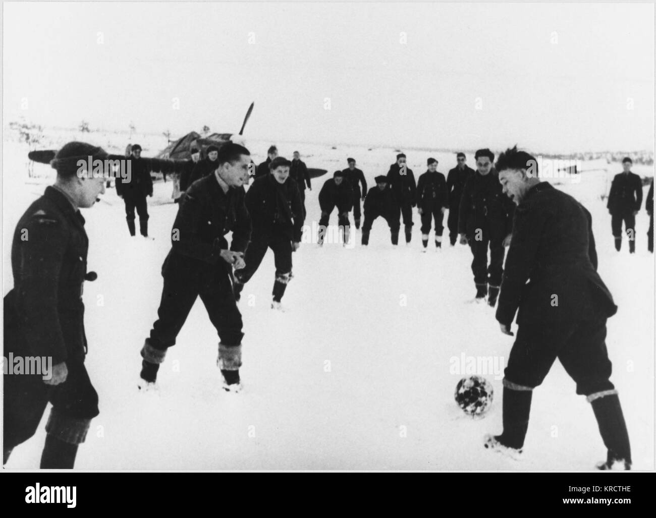Anglo-Soviet soccer match, Murmansk, RAF and Soviet Airforce. The RAF provided air-cover for convoys in their Hawker Hurricanes (background) Date: 1939 - 1945 Stock Photo
