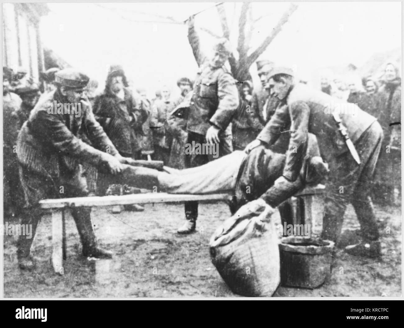 In a region of Russia overrun by the German invasion, a peasant is flogged for refusing to hand over food to the Nazis. Stock Photo