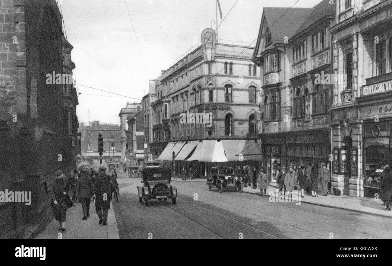 View of St Peter's Street, a busy shopping street in the centre of Derby, with traffic and pedestrians. St Peter's Church is the building on the left. Date: circa 1920 Stock Photo