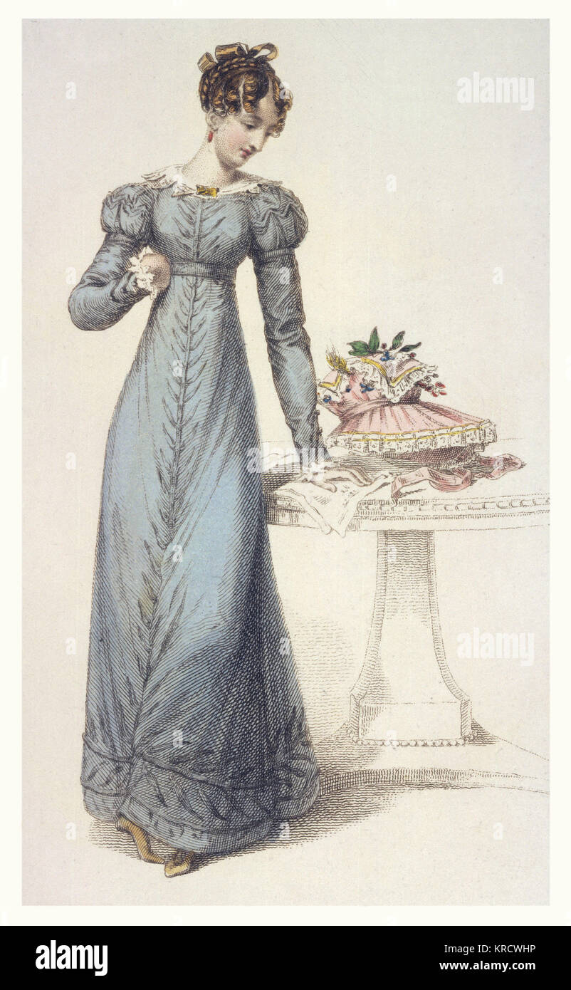 Morning Dress in blue-grey with lace cuffs &amp; collar &amp; a self-coloured, leaf motif decoration. The bonnet on the table is profusely decorated with lace, berries &amp; leaves. Date: 1823 Stock Photo