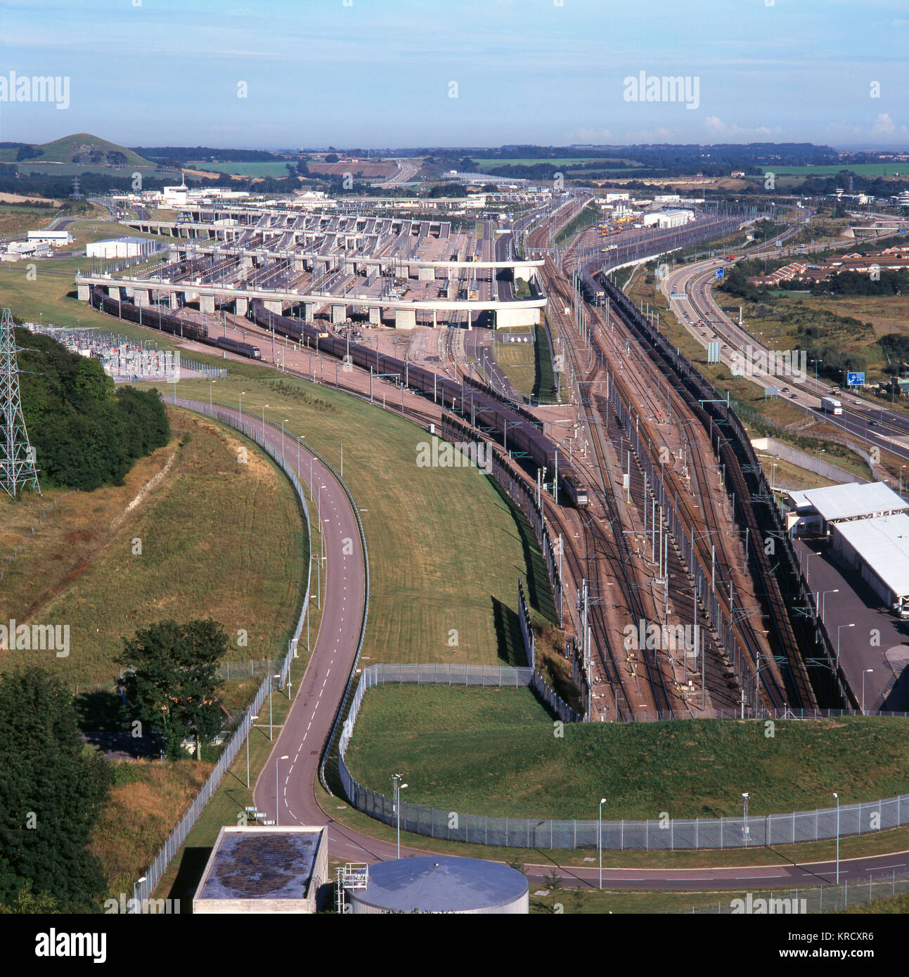 The Channel Tunnel terminal at  Folkestone, Kent, England -  view from above the tunnel  entrance, showing a Eurostar  train leaving.      Date: 1997 Stock Photo