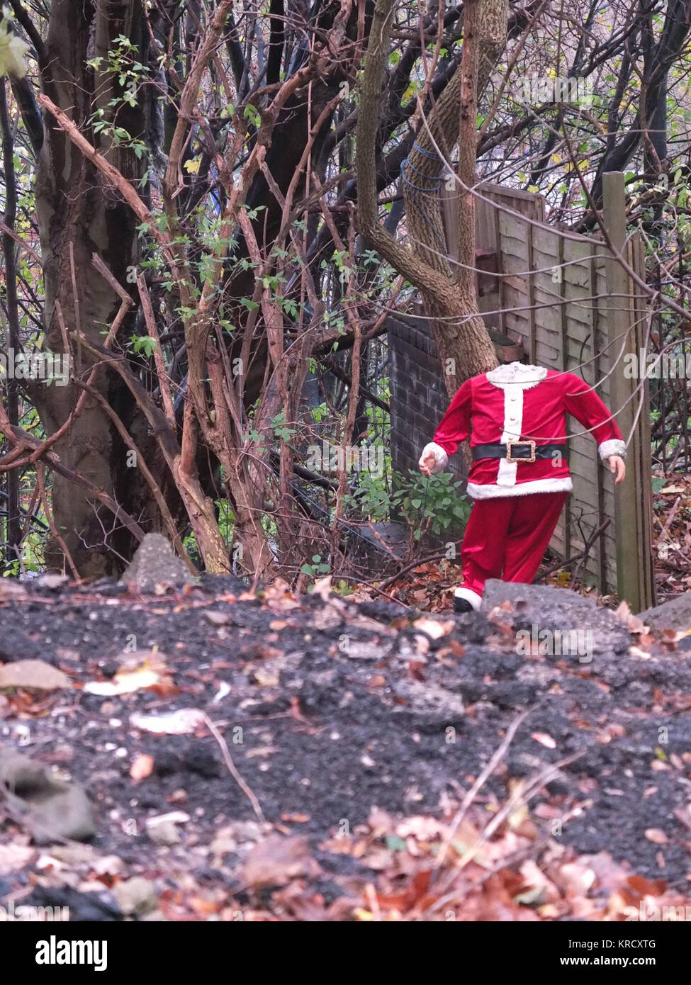 A headless Santa Claus / Father Christmas mannequin on waste ground spotted in Sheffield, UK. Stock Photo