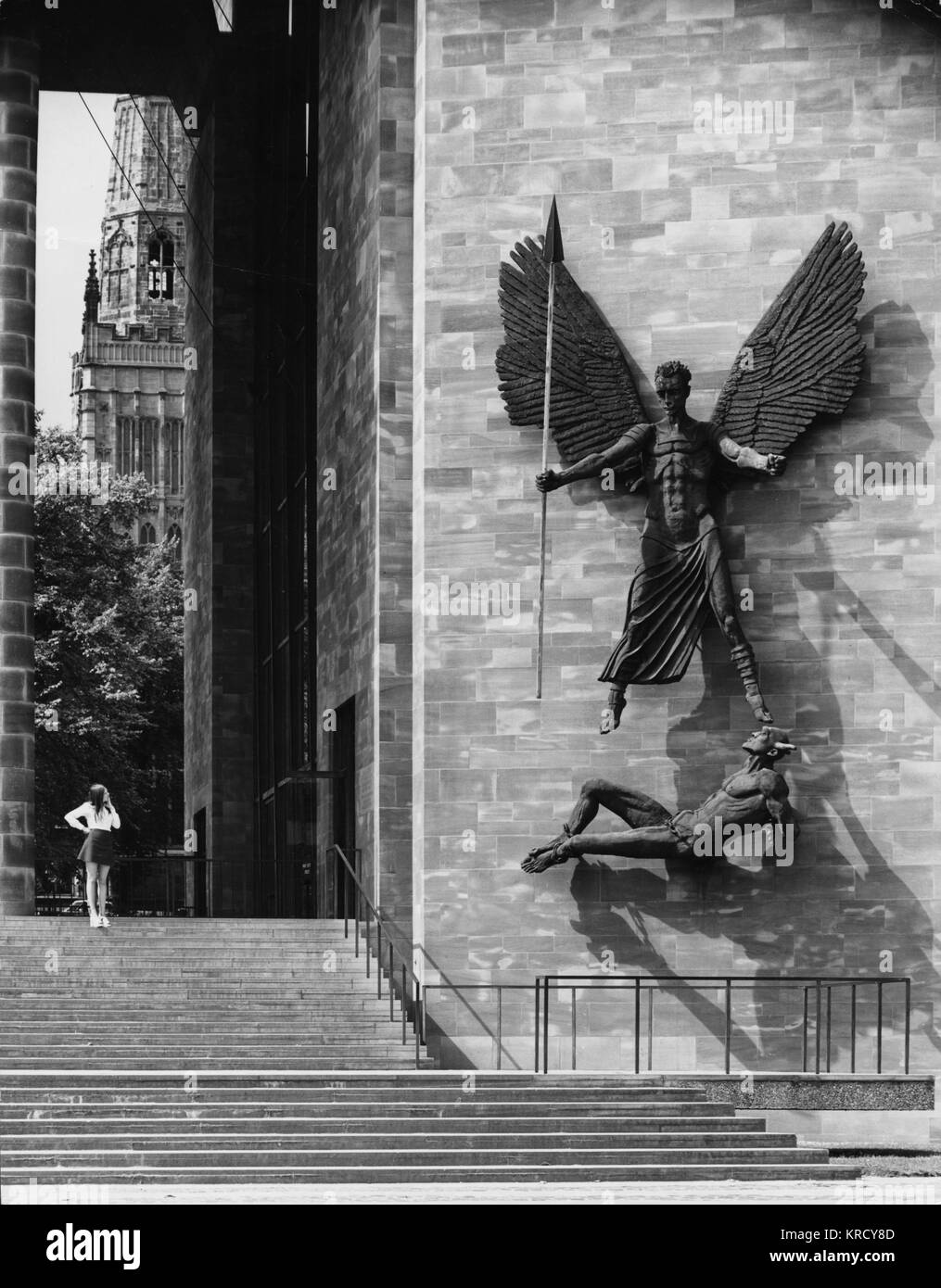 The enormous (6 metres high) sculpture of St. Michael defeating the Devil (Lucifer) sculpted (1958) by Sir Jacob Epstein, to celebrate victory over the evil of World War Two Stock Photo