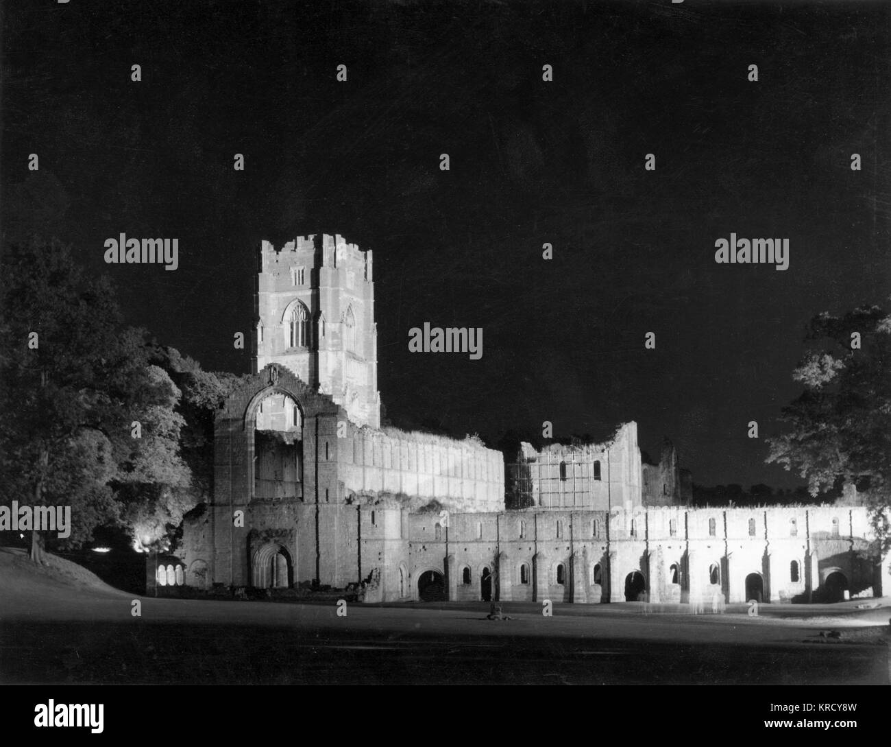 Fountains Abbey, Yorkshire,  England, a Cistercian abbey  which was founded in 1132.  Here floodlit at night.       Date: 12th century Stock Photo