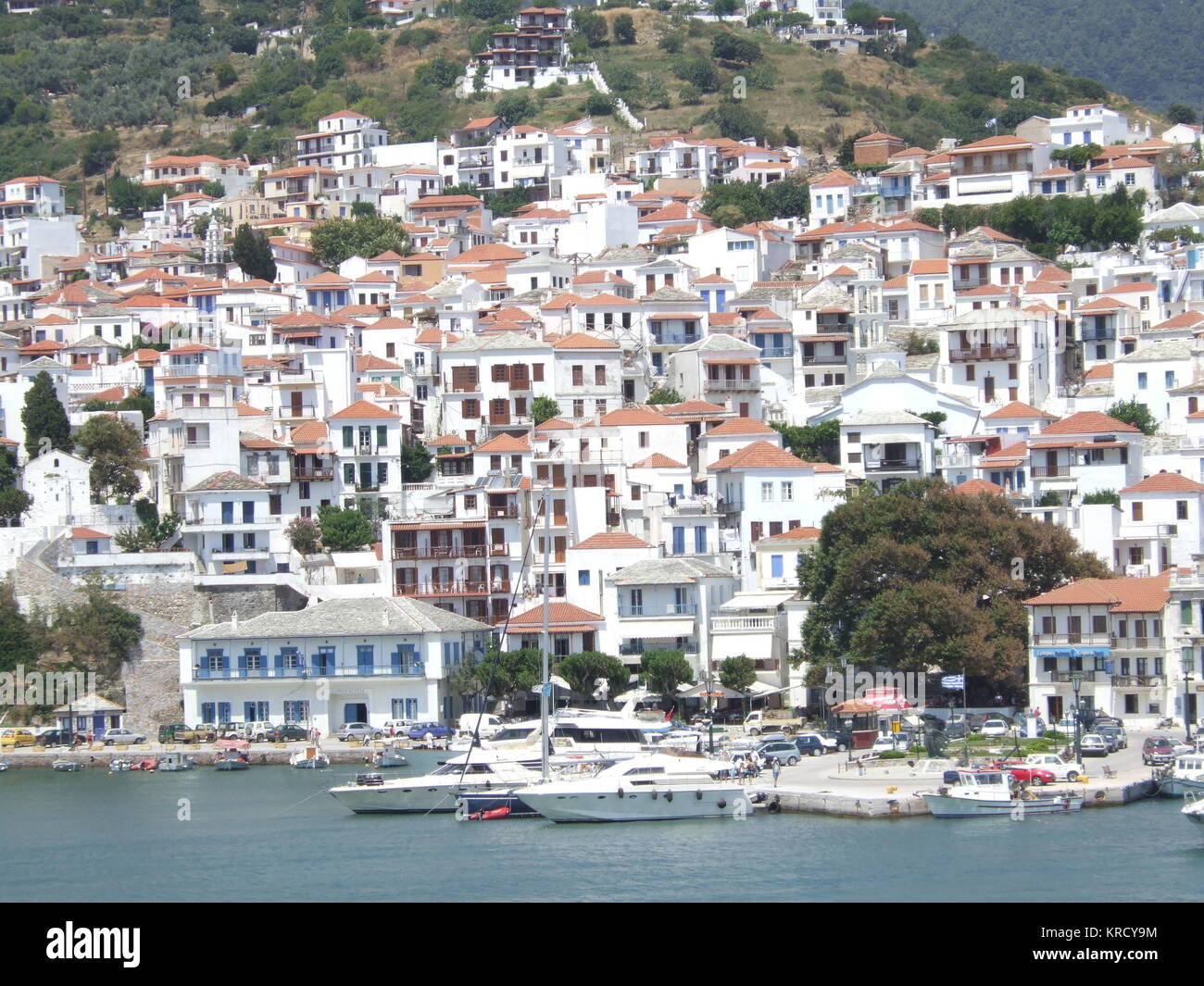 White painted housed with red  tile roofs cling to the  hillside town of Skopelos  Town, Skopelos, one of the  Sporades group of islands, of  Greece.     Date: 2006 Stock Photo