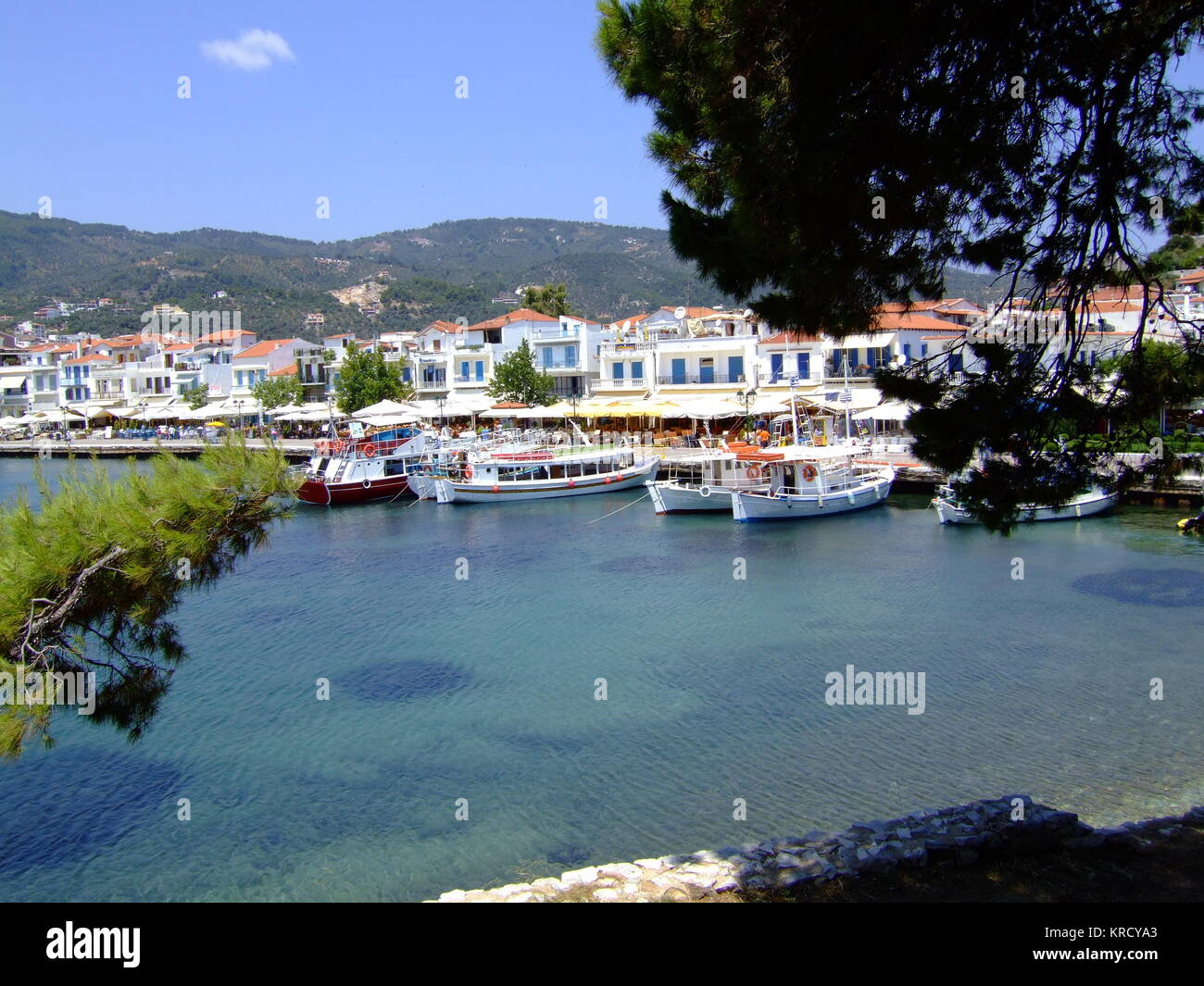 Skiathos Town, Skiathos,  Greece.  Fishing boats, tour  boats and fish restaurants  line the harbour.       Date: 2006 Stock Photo