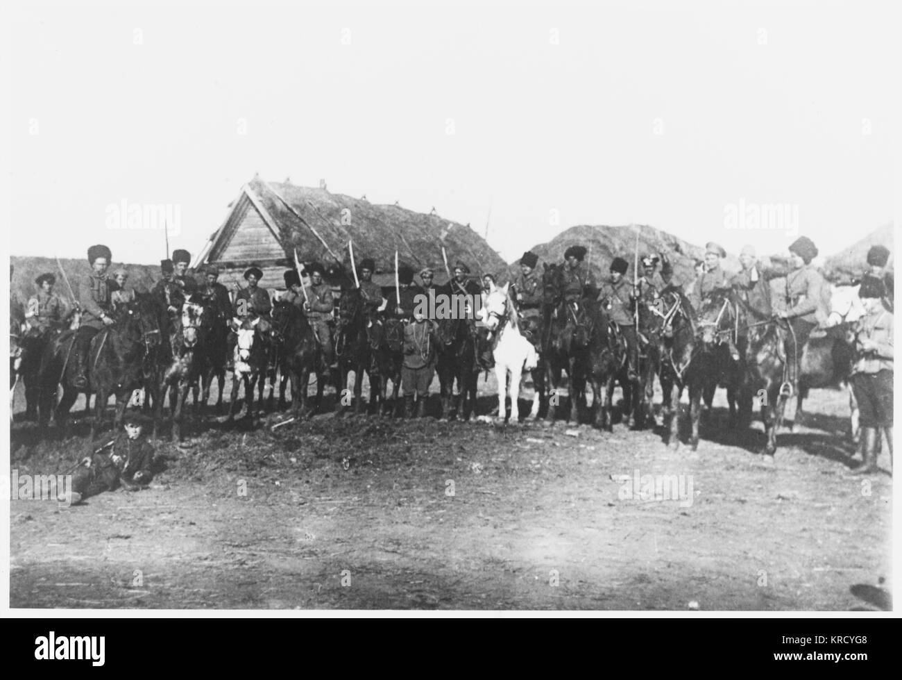 The legendary horsemanship of  the Cossacks ensures that the  Red Army cavalry is uniquely  effective : this detachment  pose for their photograph in a  Ukrainian village.     Date: 1918 Stock Photo